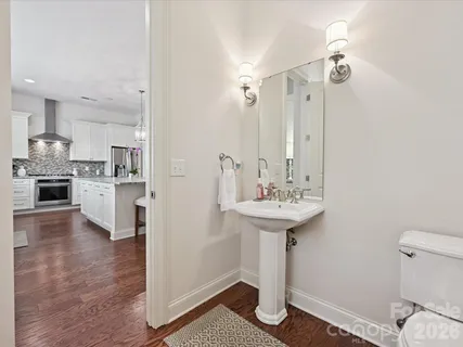 a bathroom with a sink a mirror and a toilet