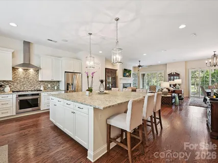 a large kitchen with lots of counter space a sink appliances and dining table