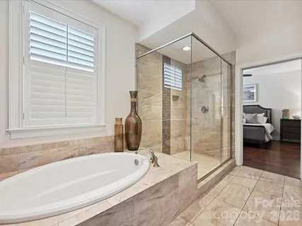 a spacious bathroom with a granite countertop tub and a shower