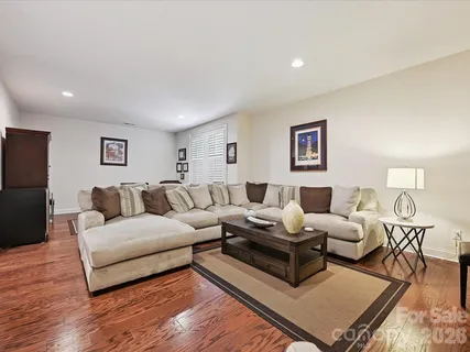 a living room with furniture rug and wooden floor