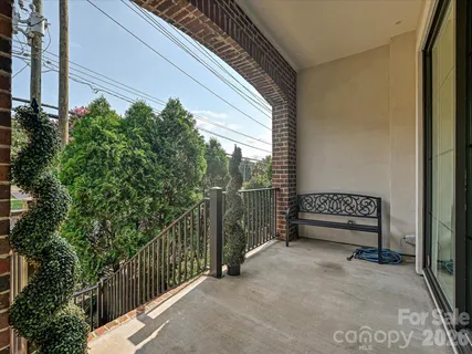 a view of a porch with wooden floor and bench
