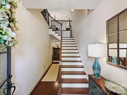 a view of entryway and hall with wooden floor