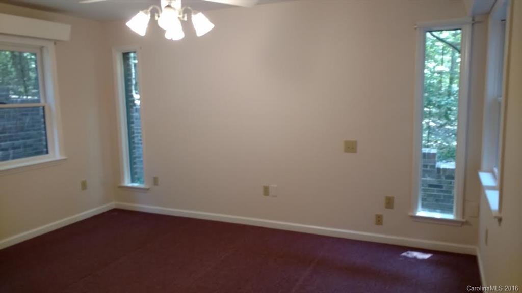 5011 Addison Road Waxhaw, NC 28173 - Photo 14 of 23 an empty room with wooden floor and windows
