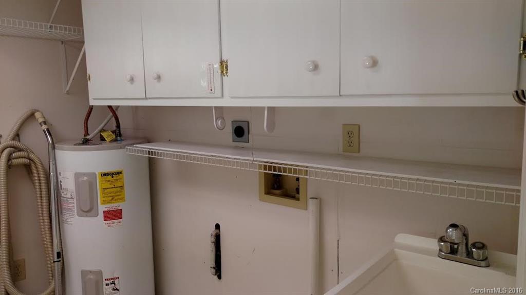 5011 Addison Road Waxhaw, NC 28173 - Photo 9 of 23 a view of cabinets and utility room with washer and dryer