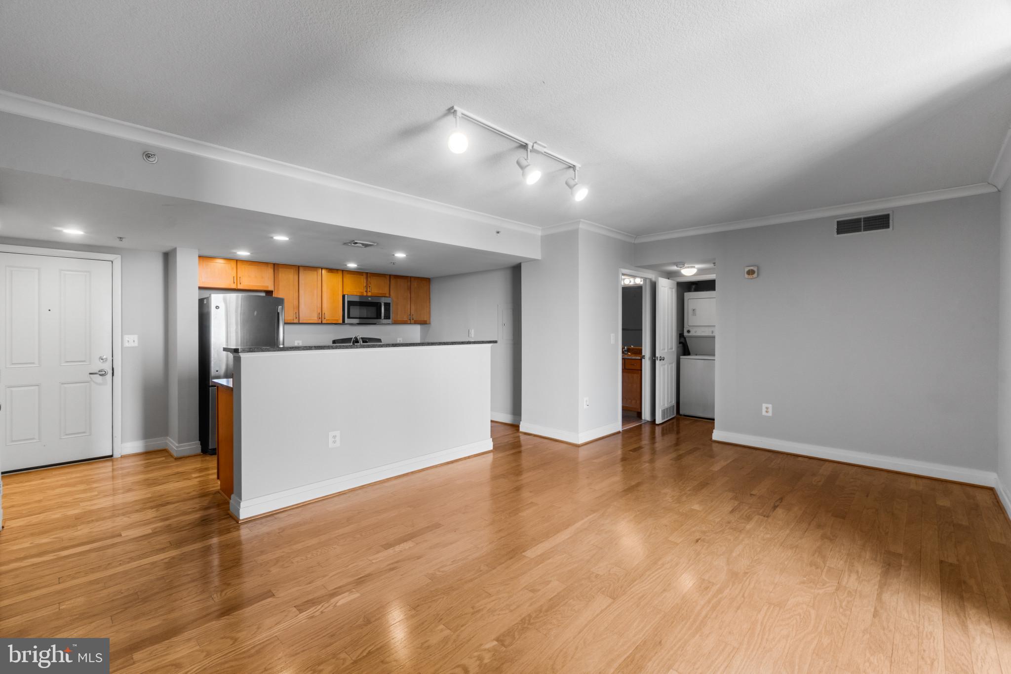 414 Water Street, Unit 1315 Baltimore, MD 21202 - Photo 11 of 30 a view of a kitchen with a sink and a refrigerator