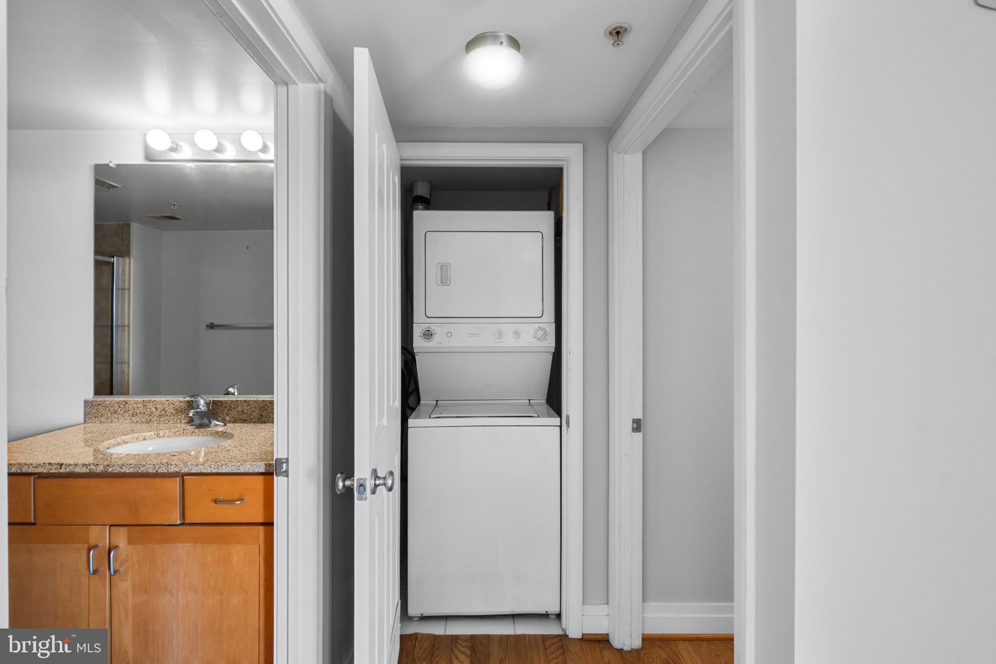 414 Water Street, Unit 1315 Baltimore, MD 21202 - Photo 12 of 30 a bathroom with a granite countertop sink and a mirror