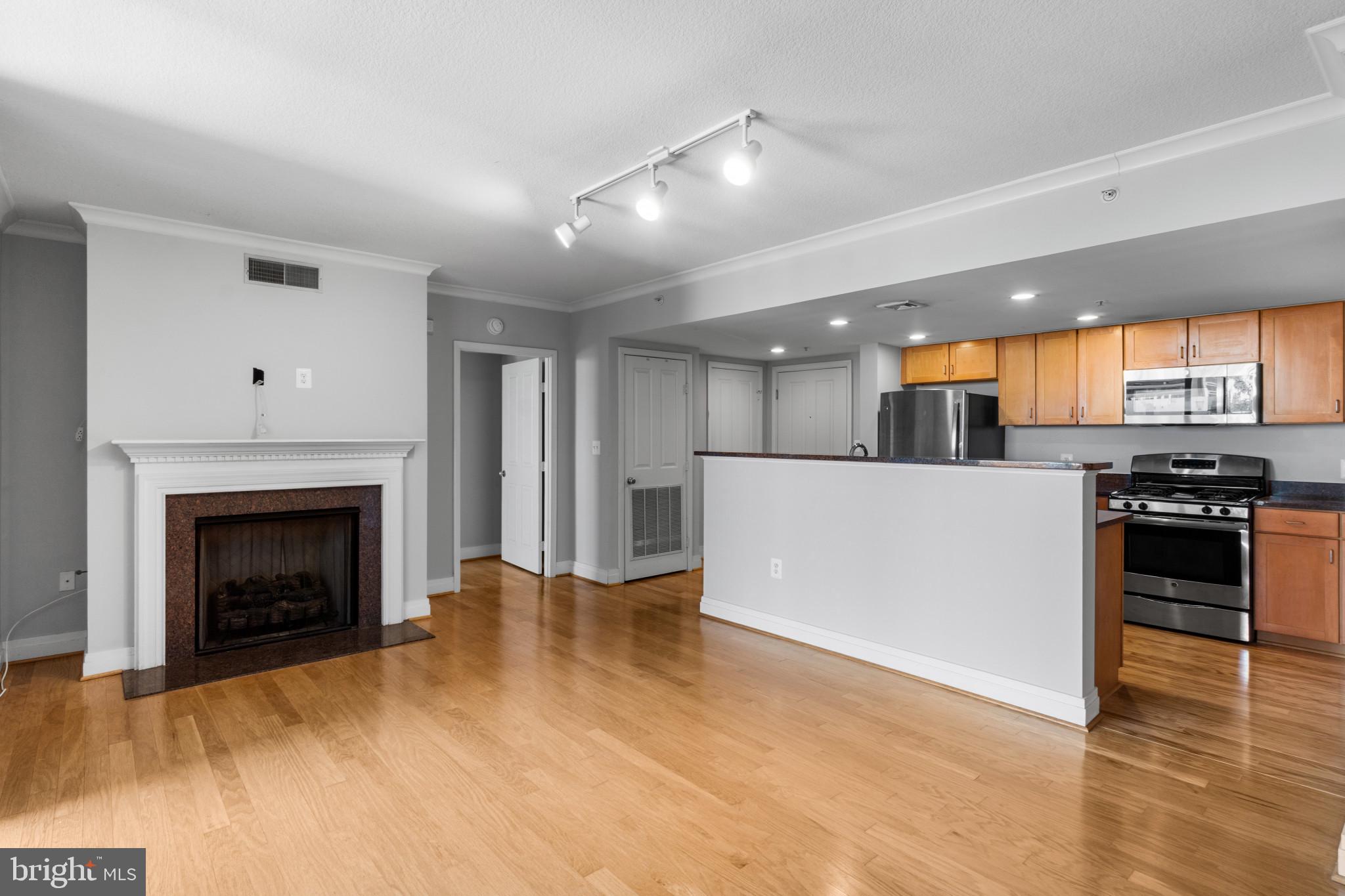 414 Water Street, Unit 1315 Baltimore, MD 21202 - Photo 13 of 30 a view of kitchen with kitchen island wooden floor center island and stainless steel appliances