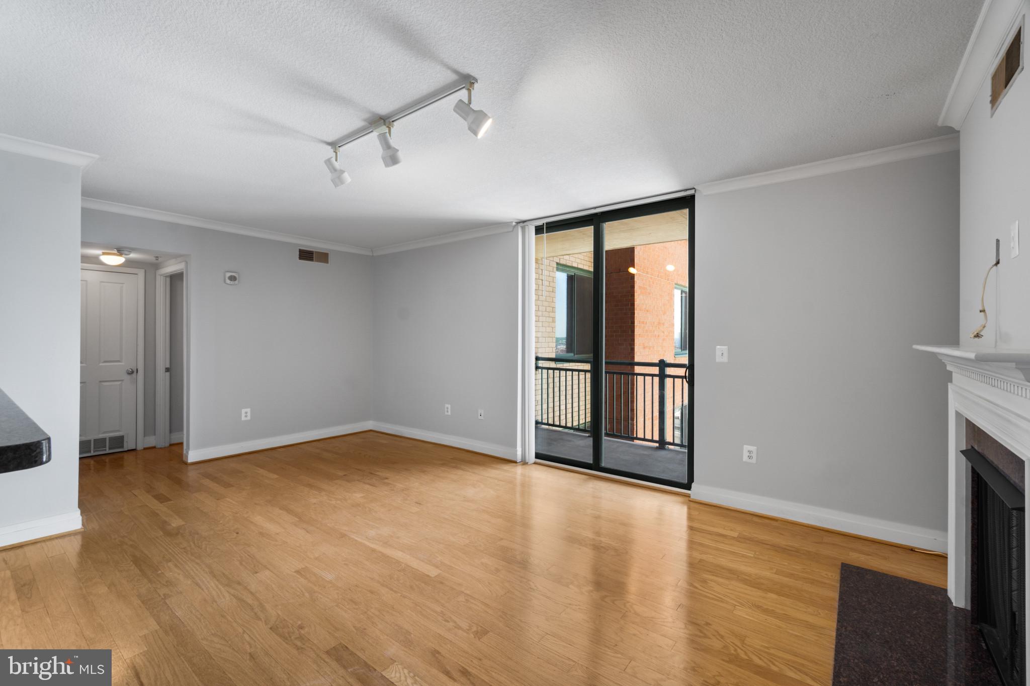 414 Water Street, Unit 1315 Baltimore, MD 21202 - Photo 15 of 30 a view of an empty room with wooden floor and a window