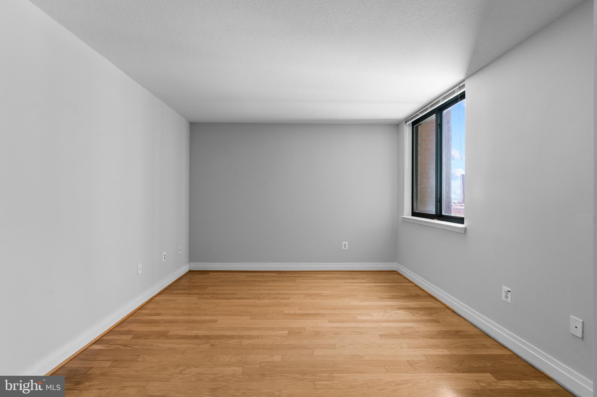 414 Water Street, Unit 1315 Baltimore, MD 21202 - Photo 20 of 30 a view of room with window and hardwood floor