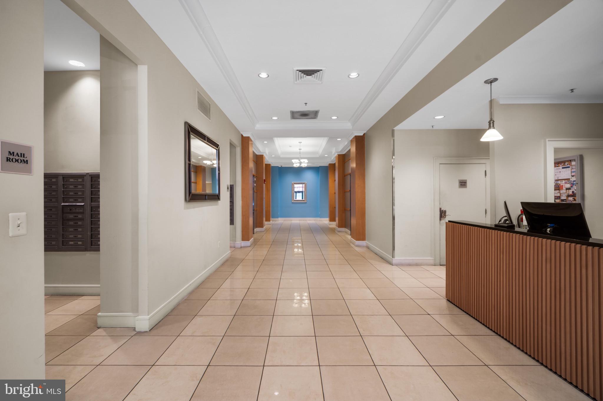 414 Water Street, Unit 1315 Baltimore, MD 21202 - Photo 26 of 30 a view of hallway with a window and chandelier