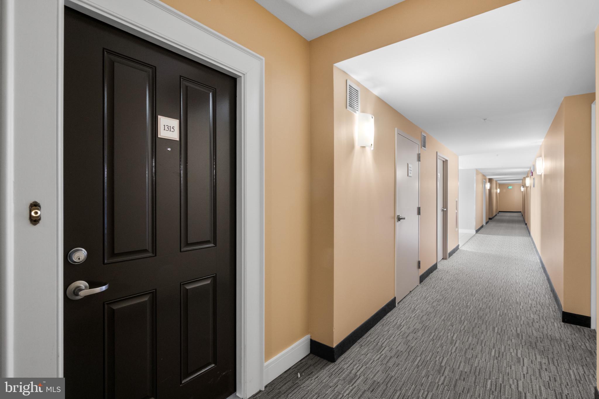 414 Water Street, Unit 1315 Baltimore, MD 21202 - Photo 4 of 30 a view of a hallway with wooden floor