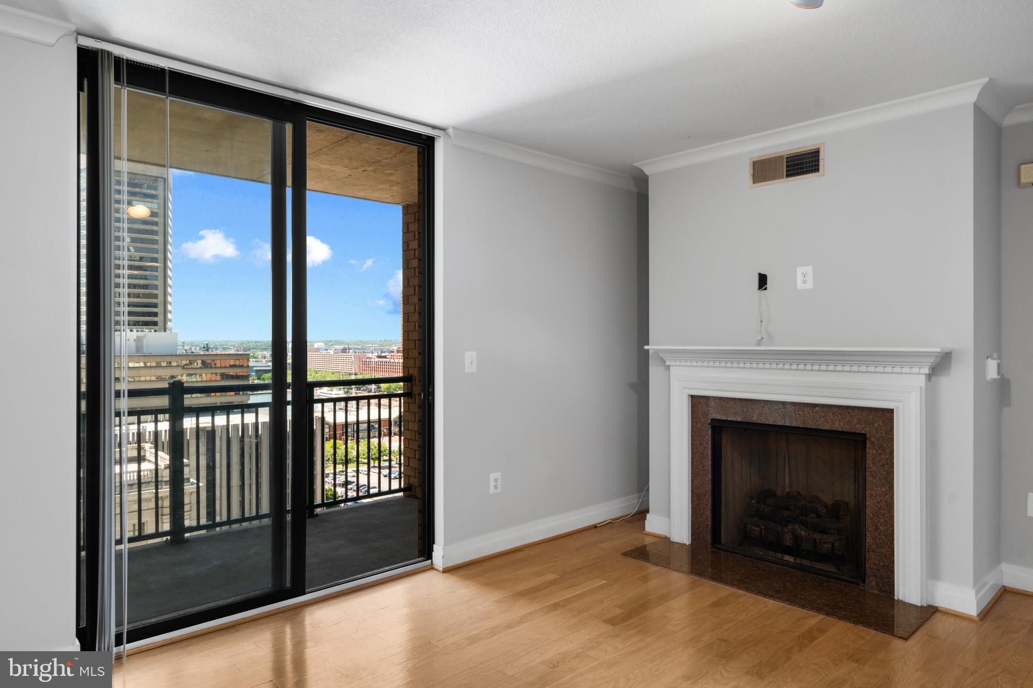 414 Water Street, Unit 1315 Baltimore, MD 21202 - Photo 10 of 30 a view of an empty room with a fireplace