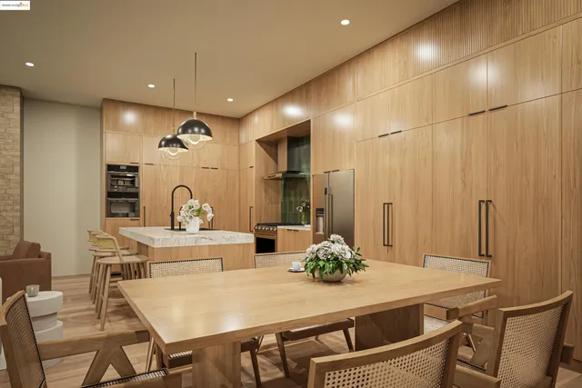 a living room with furniture kitchen view and a chandelier