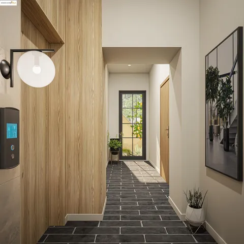 a view of a hallway with wooden floor and a bathroom