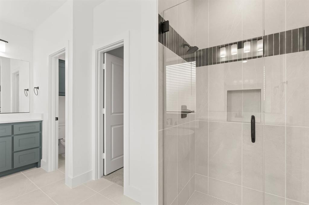 413 Tower Street DeSoto, TX 75115 - Photo 22 of 30 a bathroom with a shower and a glass door