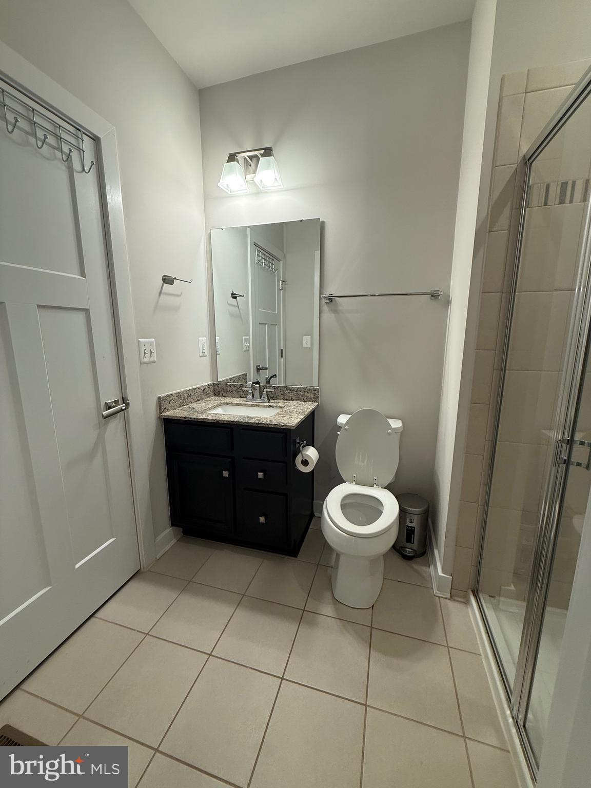 440 Tree Of Heaven Way Newark, DE 19713 - Photo 12 of 27 a bathroom with a granite countertop toilet a sink a mirror a vanity and a glass door shower