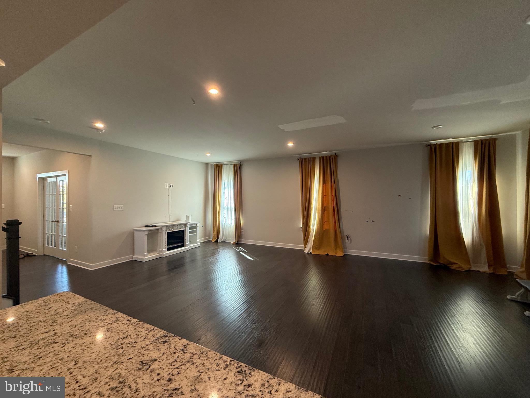 440 Tree Of Heaven Way Newark, DE 19713 - Photo 7 of 27 a view of an empty room with wooden floor and a window