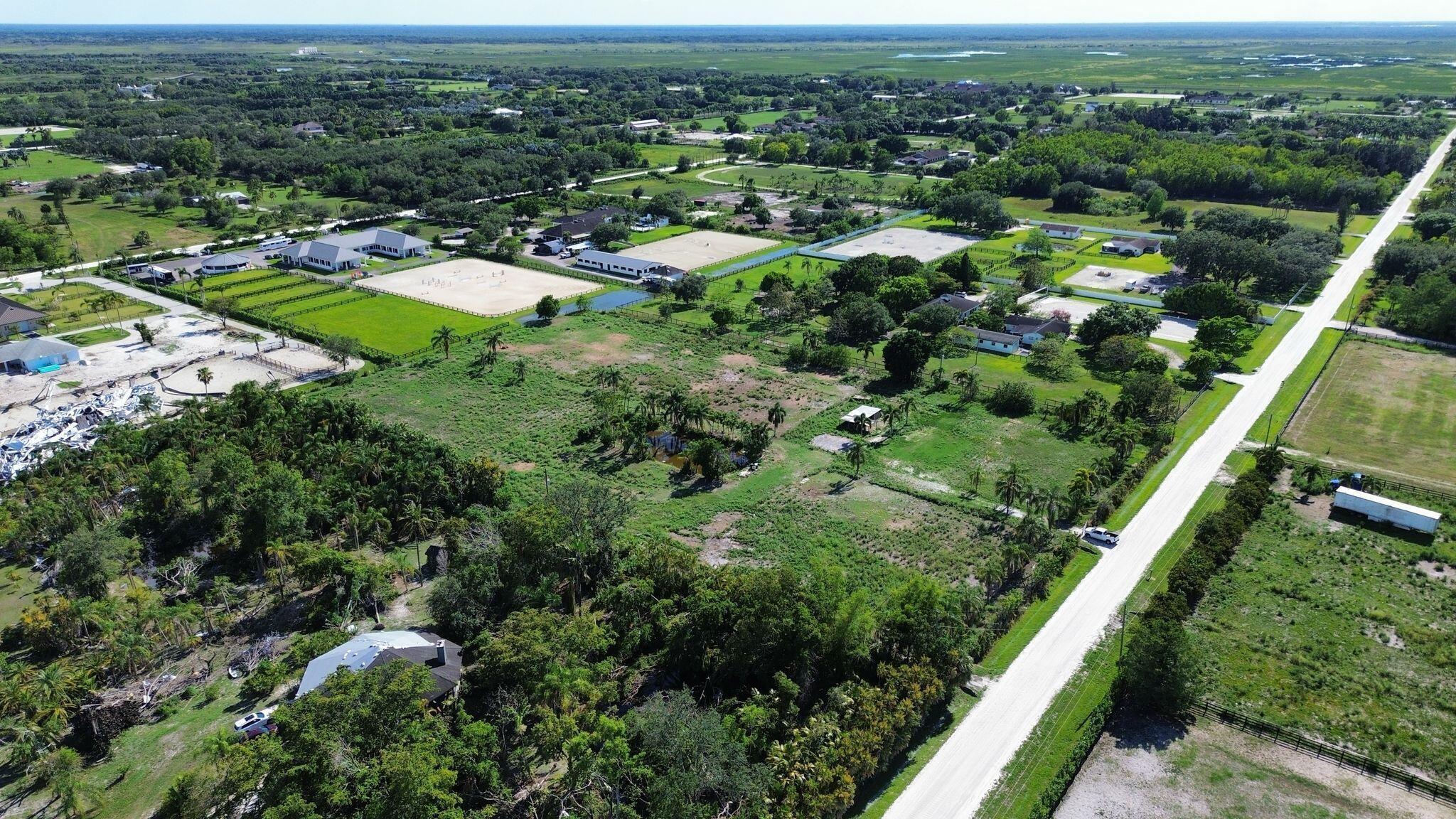 16290 Rustic Road Wellington, FL 33470 - Photo 3 of 20 an aerial view of residential houses with outdoor space and trees
