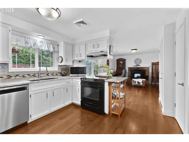 a kitchen with cabinets a sink and appliances