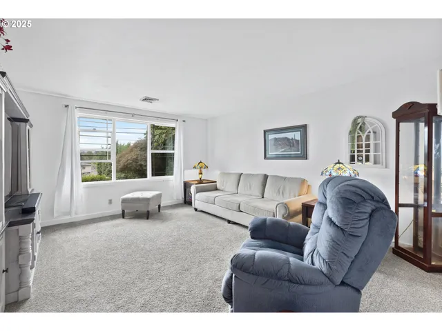 a living room with furniture large window and flat screen tv
