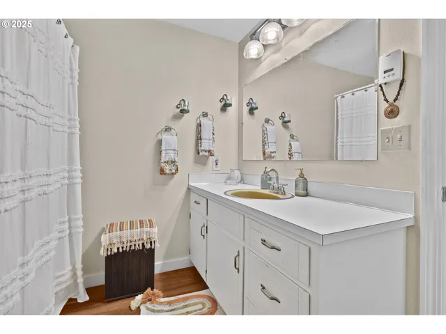 a bathroom with a sink vanity and a mirror