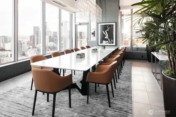 a dining room with furniture and a large window