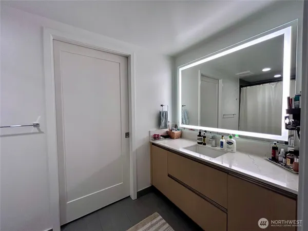 a bedroom with a large window and a flat screen tv