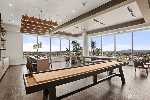 a kitchen with a table chairs and wooden floor