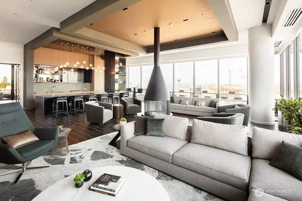 a living room with furniture and floor to ceiling windows