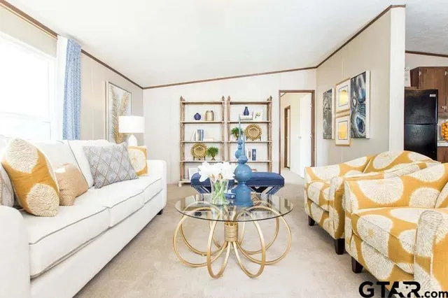 a living room with furniture and a floor to ceiling window