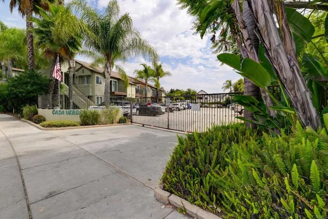a view of a yard with plants and lake view