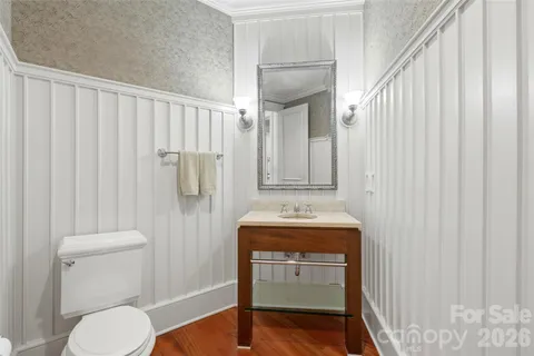 a bathroom with a toilet a sink and curtain