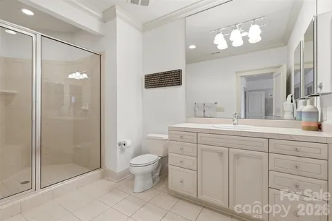 a spacious bathroom with a double vanity sink mirror and toilet