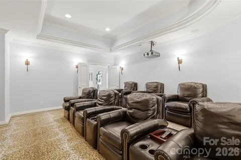 a media room with lots of chairs and mirrors