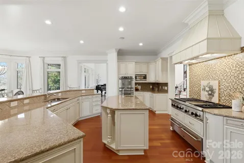 a kitchen with stainless steel appliances granite countertop a stove and a sink