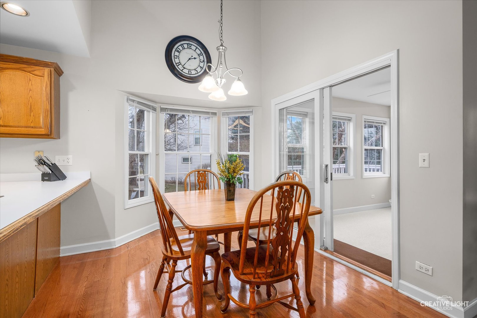 2262 Brookside Lane Aurora, IL 60502 - Photo 8 of 37 a dining room with furniture a clock and wooden floor