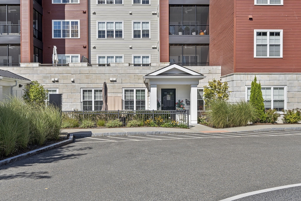 a front view of a building with a garden