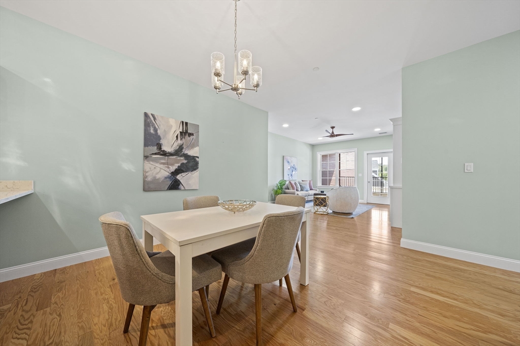 15 Revolution Way, Unit 2107 Canton, MA 02021 - Photo 12 of 40 a view of a dining room with furniture wooden floor and chandelier