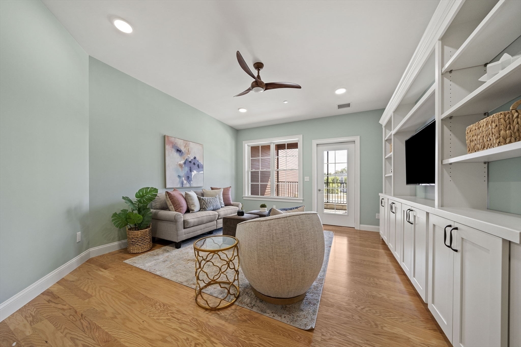15 Revolution Way, Unit 2107 Canton, MA 02021 - Photo 15 of 40 a living room with furniture windows and a flat screen tv
