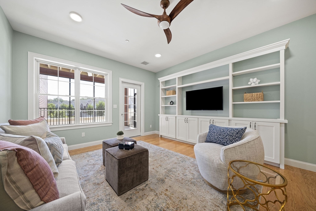 15 Revolution Way, Unit 2107 Canton, MA 02021 - Photo 16 of 40 a living room with furniture and a flat screen tv