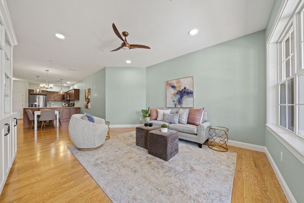 15 Revolution Way, Unit 2107 Canton, MA 02021 - Photo 17 of 40 a living room with furniture a wooden floor and a large window