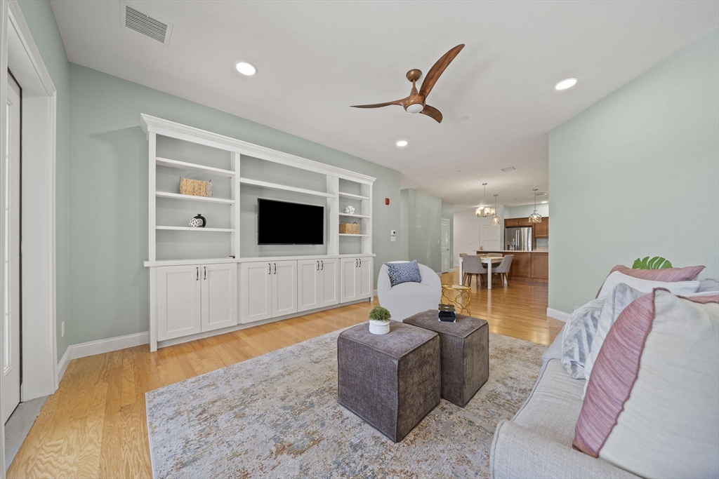 15 Revolution Way, Unit 2107 Canton, MA 02021 - Photo 18 of 40 a living room with furniture and a flat screen tv