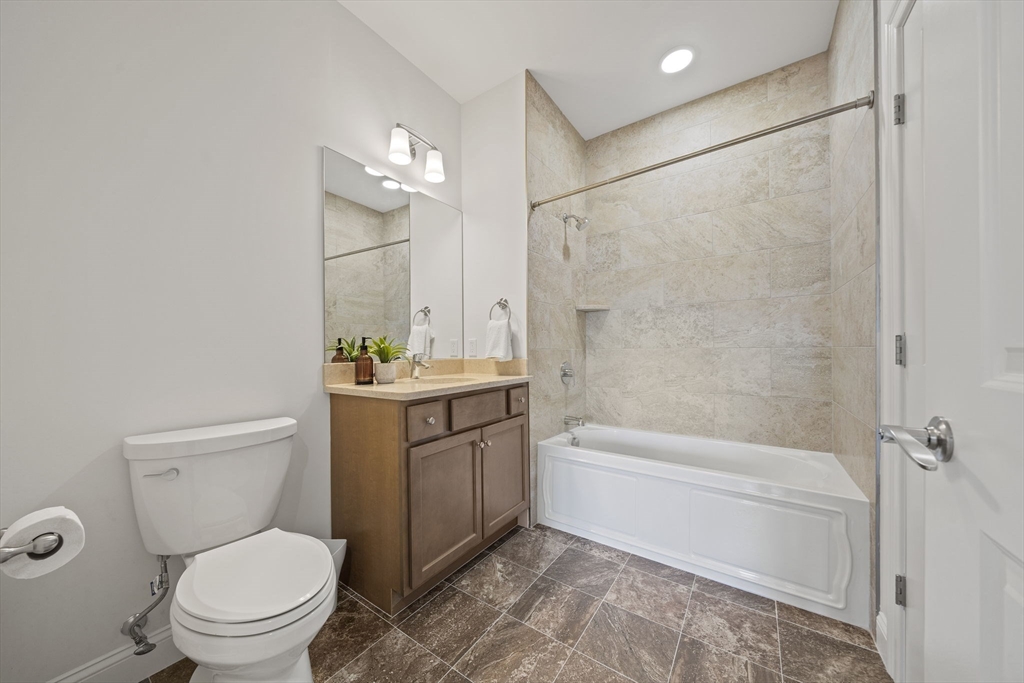 15 Revolution Way, Unit 2107 Canton, MA 02021 - Photo 19 of 40 a bathroom with a sink a toilet and a bathtub