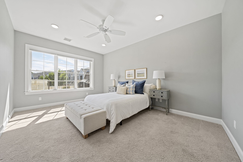 15 Revolution Way, Unit 2107 Canton, MA 02021 - Photo 20 of 40 a spacious bedroom with a bed and a window