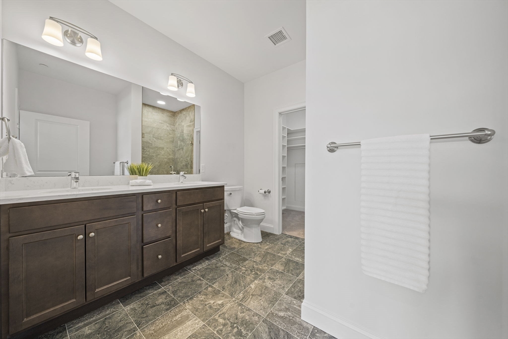 15 Revolution Way, Unit 2107 Canton, MA 02021 - Photo 24 of 40 a spacious bathroom with a double vanity sink toilet mirror and shower