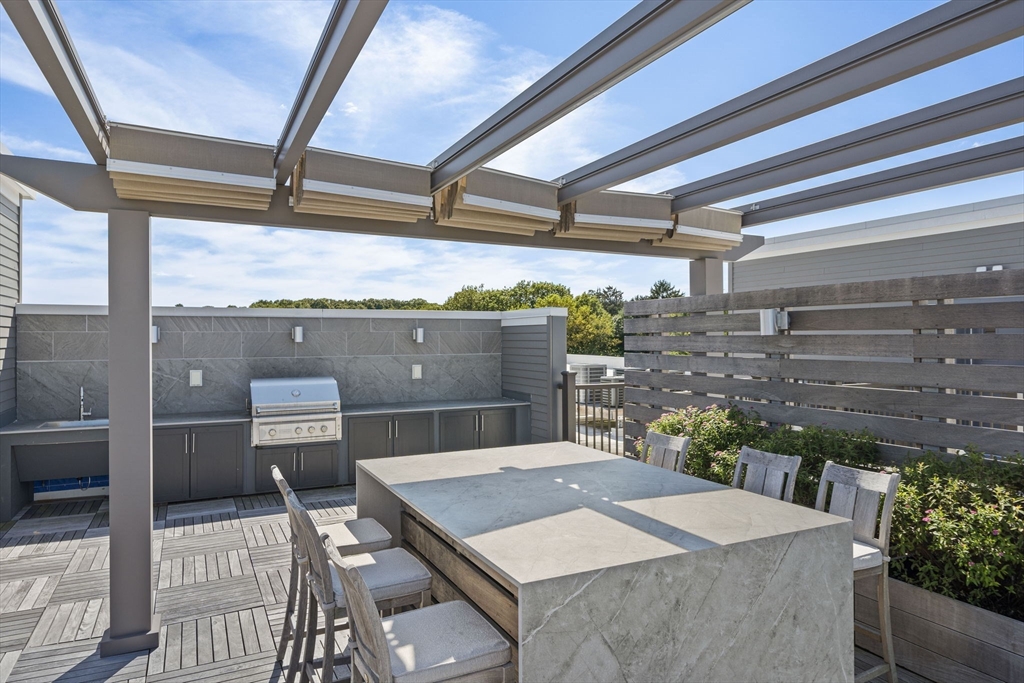 15 Revolution Way, Unit 2107 Canton, MA 02021 - Photo 33 of 40 a view of a patio with table and chairs