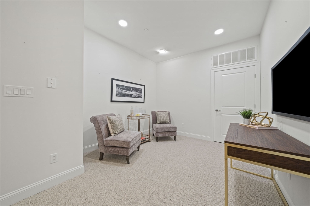 15 Revolution Way, Unit 2107 Canton, MA 02021 - Photo 5 of 40 a living room with furniture and a flat screen tv