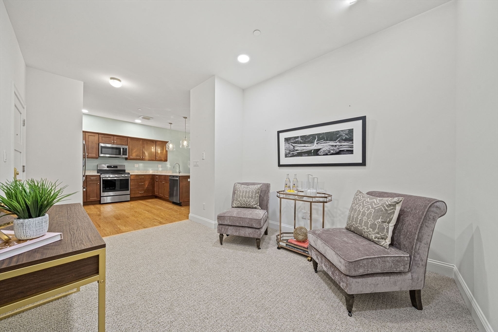 15 Revolution Way, Unit 2107 Canton, MA 02021 - Photo 6 of 40 a living room with furniture and white walls