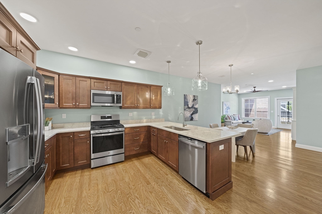 15 Revolution Way, Unit 2107 Canton, MA 02021 - Photo 7 of 40 a kitchen with stainless steel appliances granite countertop a stove oven and refrigerator
