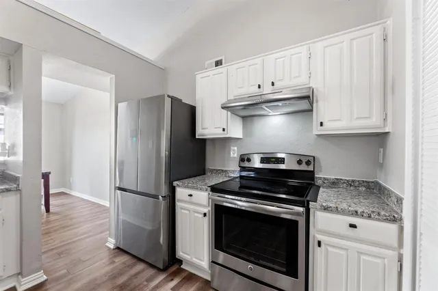 a kitchen with granite countertop cabinets and steel stainless steel appliances